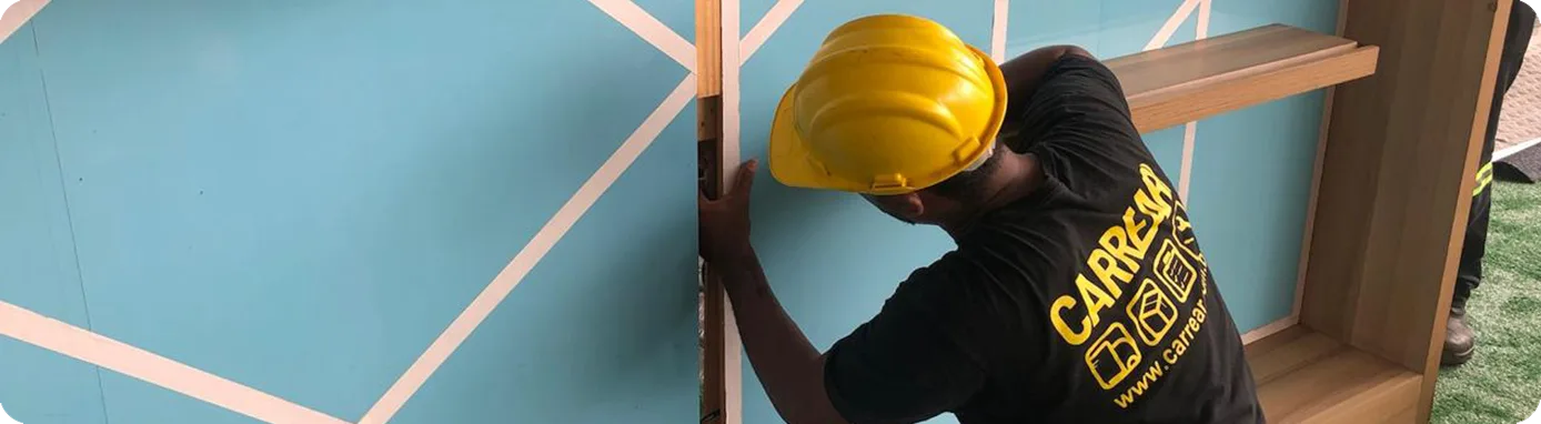 Montador de capacete instalando painel cenográfico azul